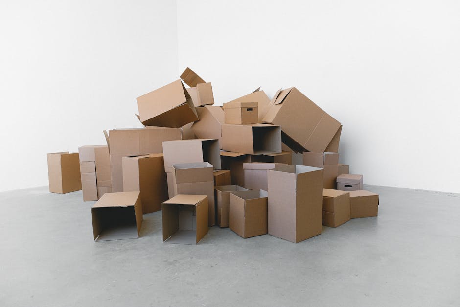 Movers packing cardboard boxes for a local relocation